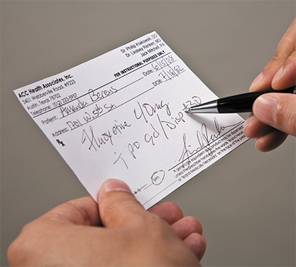Prescription being held with pen shown